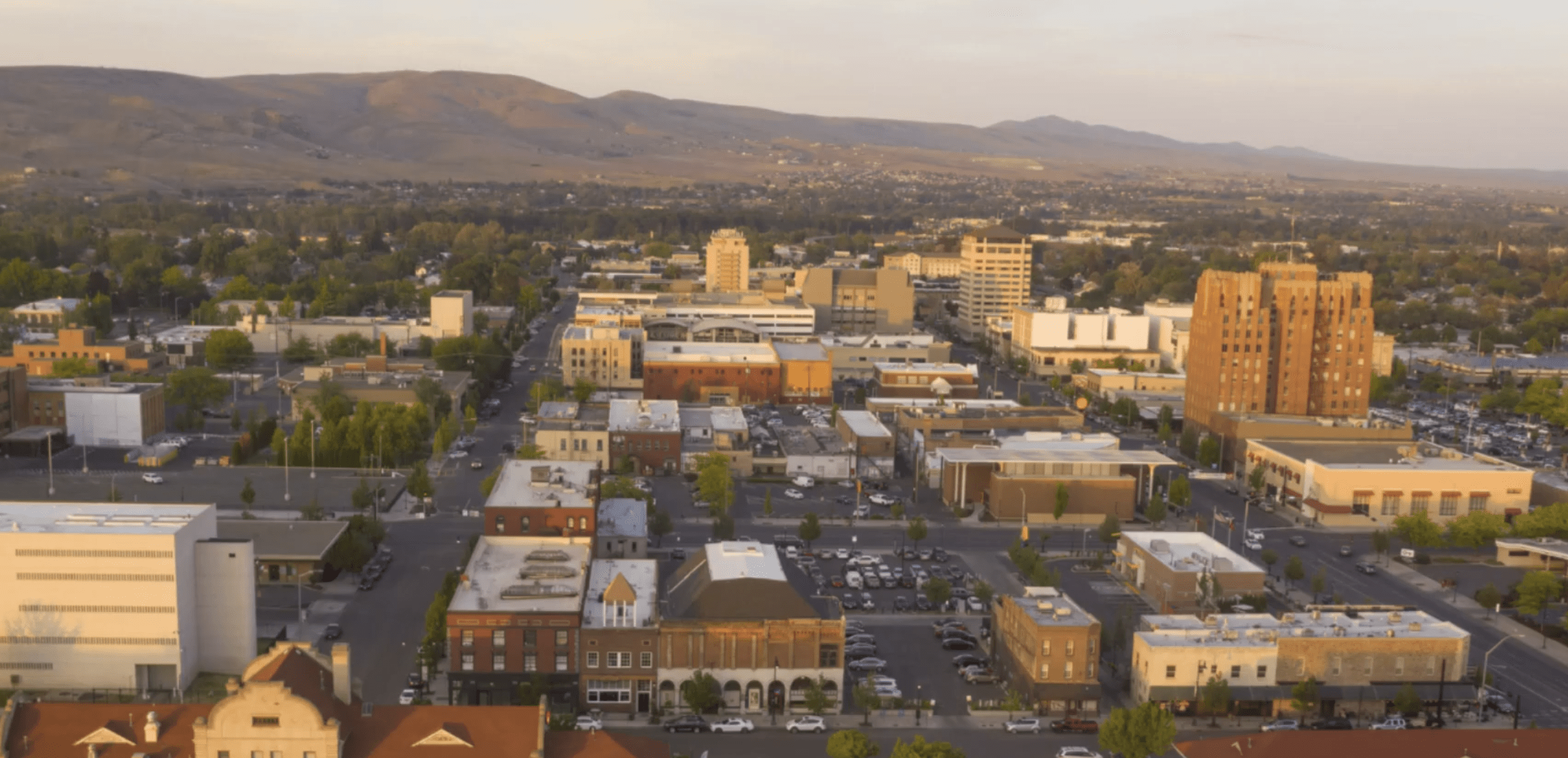Aerial view of Yakima, Washington showcasing downtown buildings, streets, and surrounding mountains, emphasizing local business visibility and community landscape for SEO optimization.